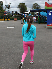 Two latina girls in tight pink leggings have fun in the park
