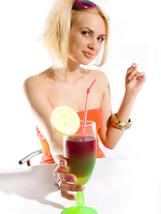 Beautiful blonde teen chick with sunglasses stripping while drinking a delicious cocktail.