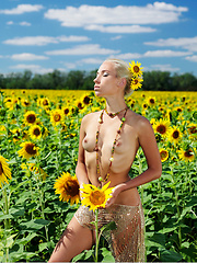 Amidst a large field of sunflowers in full bloom, Adele's natural beauty is the fairest of them all as she confidently poses her gorgeous body with perfectly erect nipples under the warm sun.