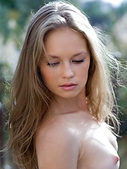 Caesaria is a young innocent girl who is outside getting a little natural light on her tender skin.