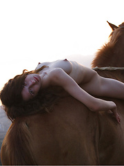 Riding in a strong horse is this brunette with kinky hair and alabaster skin.