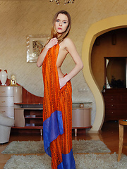With just her orange flowing shawl to   cover her slender luscious body, Katie   makes a tempting presence in the living   room, posing without any hint of   inhibition.