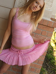 Cute blonde teen Skye teases with her perky tits outside in her pink top and short skirt with a black g-string underneath