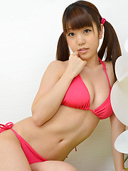 Mizuho Shiraishi with cans in pink bath suit plays with her hair