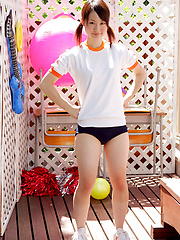 Naoko Sawano Asian in sports outfit plays with balls in garden