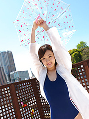 Kana Yuuki Asian in bath suit plays with umbrella in the balcony