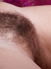 Vera strips naked in bed showing her hairy pussy